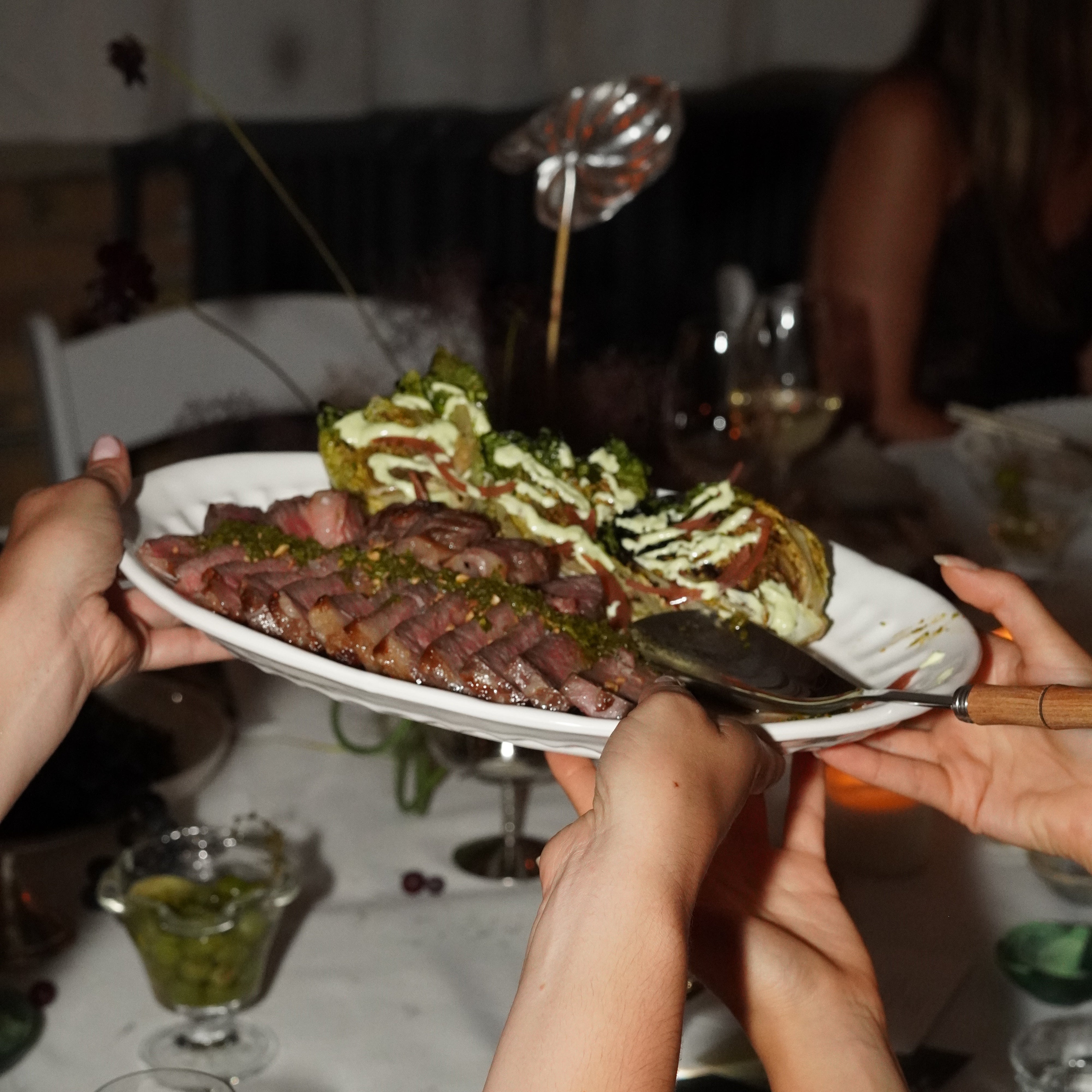Person holding a plate with food, possibly at an event or gathering.