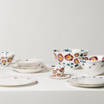 Set of ceramic dishes with floral patterns on a white background