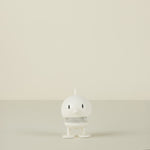 White  character on a beige background