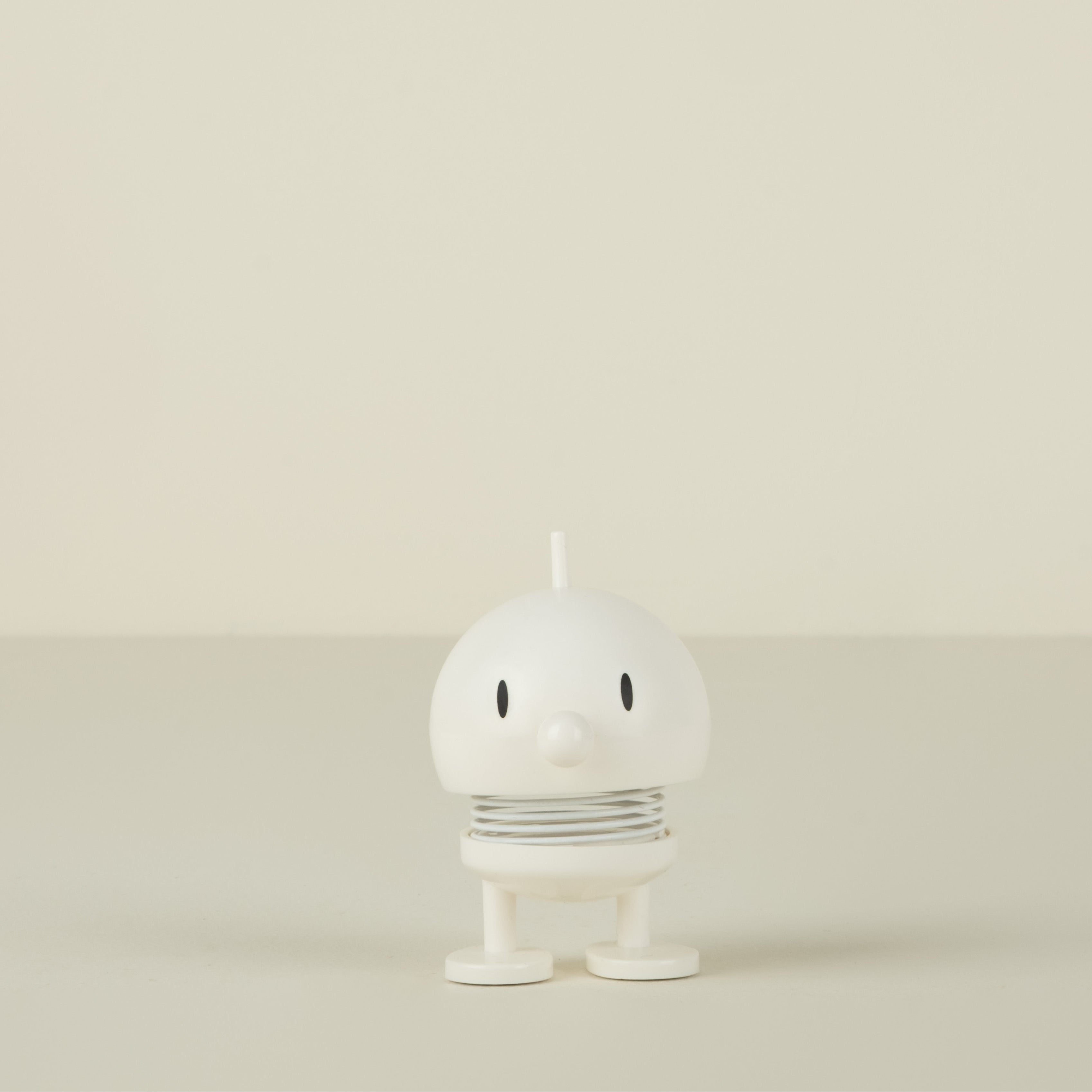 White  character on a beige background