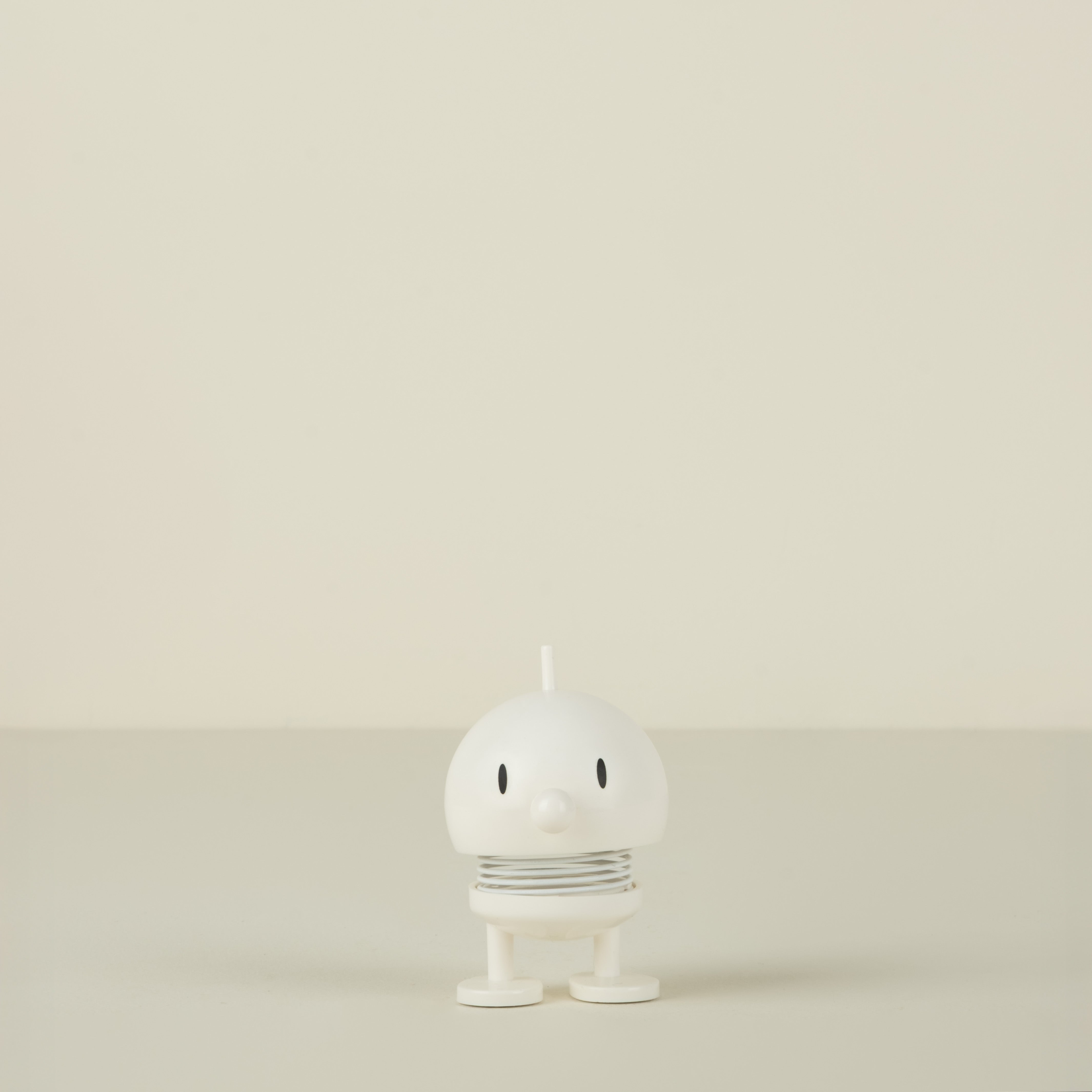 White  character on a beige background