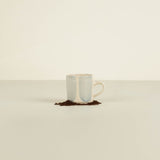 Ceramic mug with a light blue interior and beige exterior on a white background