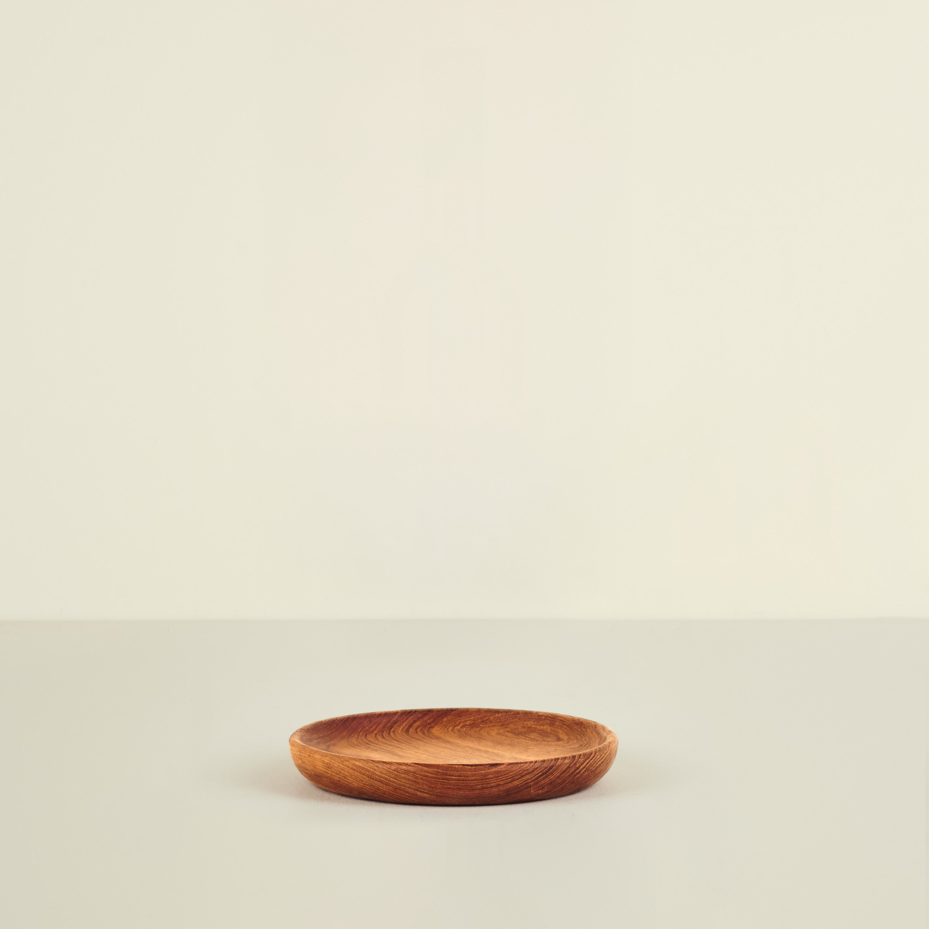 Wooden plate on a beige background