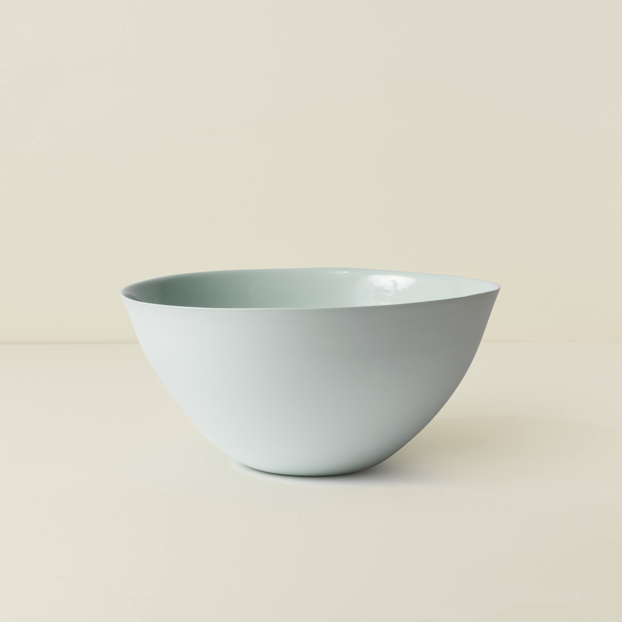 Light blue ceramic bowl on a beige background
