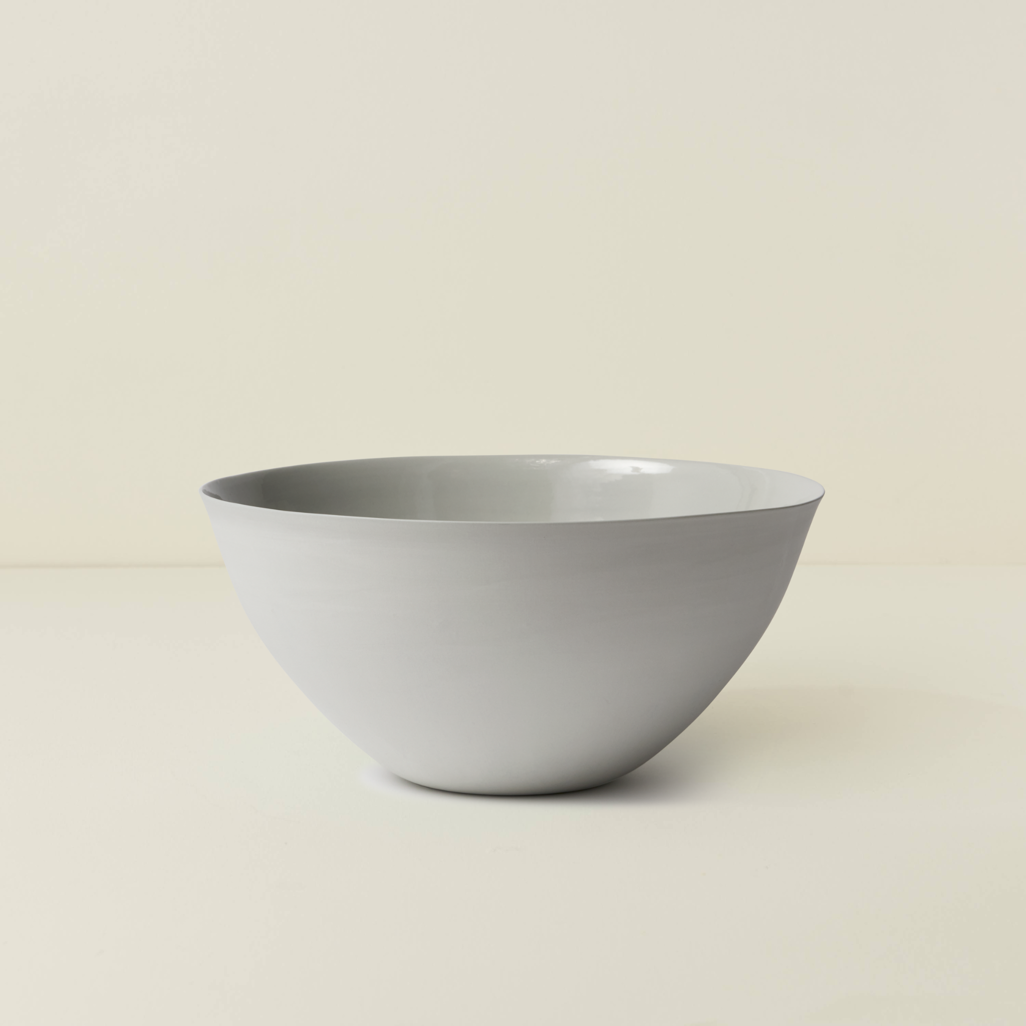 White ceramic bowl on a beige background