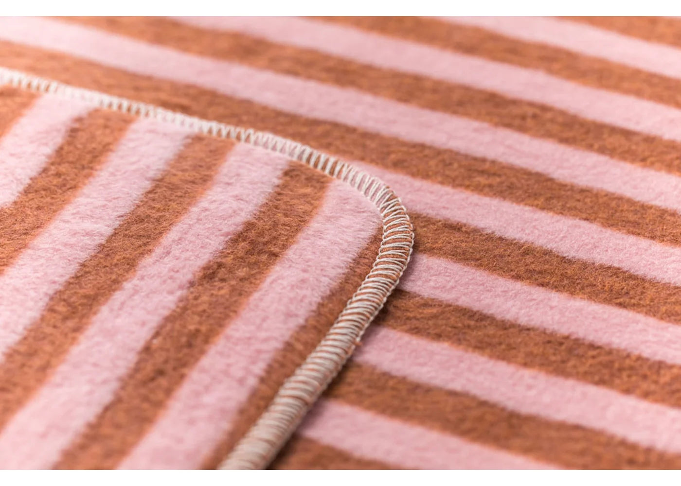 Close-up of a fabric with pink and brown striped pattern
