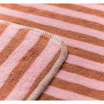 Close-up of a fabric with pink and brown striped pattern