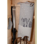 Wooden closet with skis, a folded gray throw, and a chair with a fur cushion.