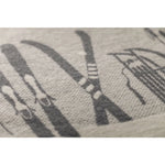 Close-up of a textured fabric with printed ski patterns on a light gray background