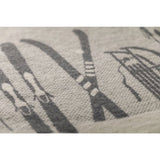 Close-up of a textured fabric with printed ski patterns on a light gray background