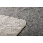 Close-up of a textured gray throw corner