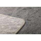 Close-up of a textured gray throw corner